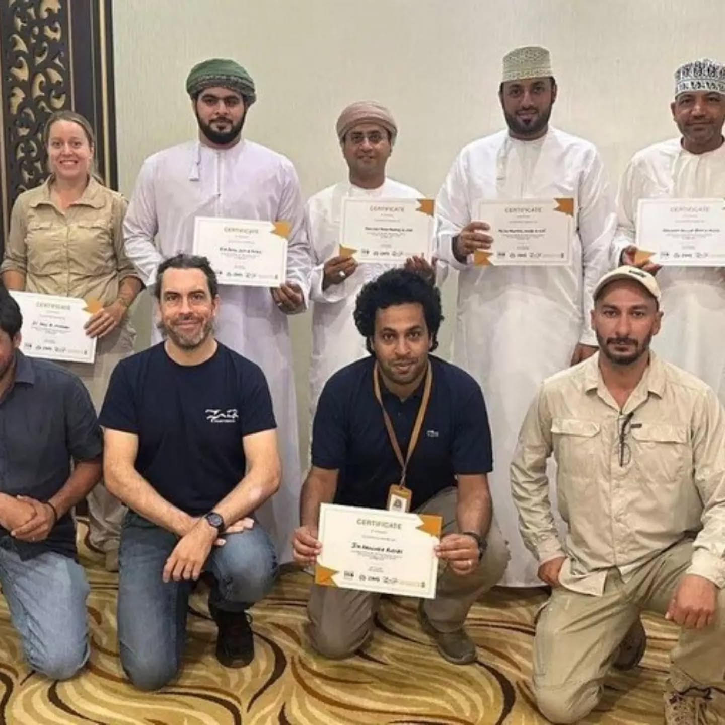 A group of professionals holding their completion certificates